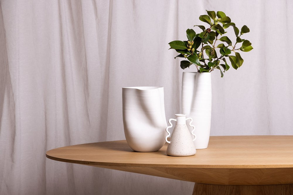 Three vases sitting on a table