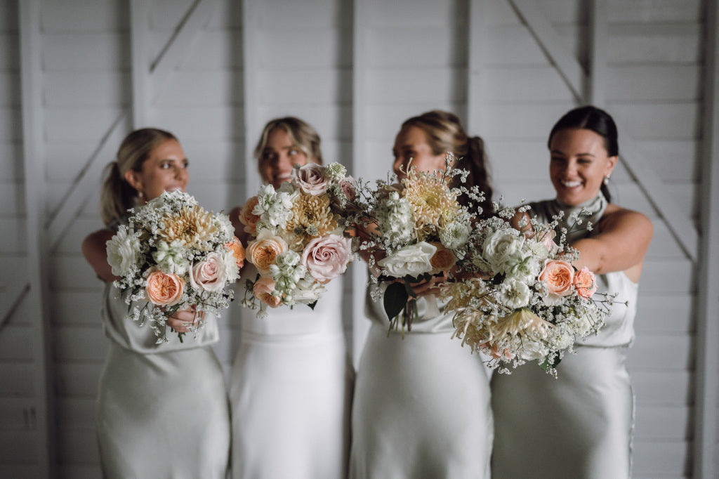 Bridesmaids with fresh flower bouquets