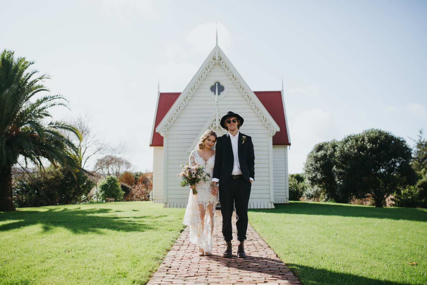 Bride & Groom in front of church flowers wedding