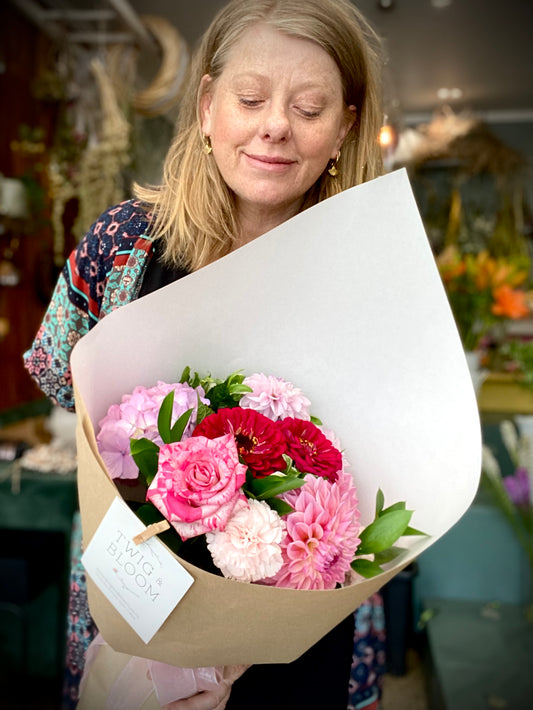 Woman holding a small fresh flower bouquet