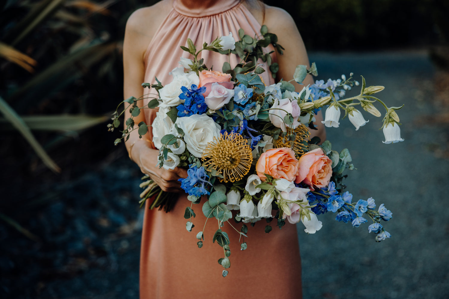 Blue, yellow, peach, and white bridal bouquet