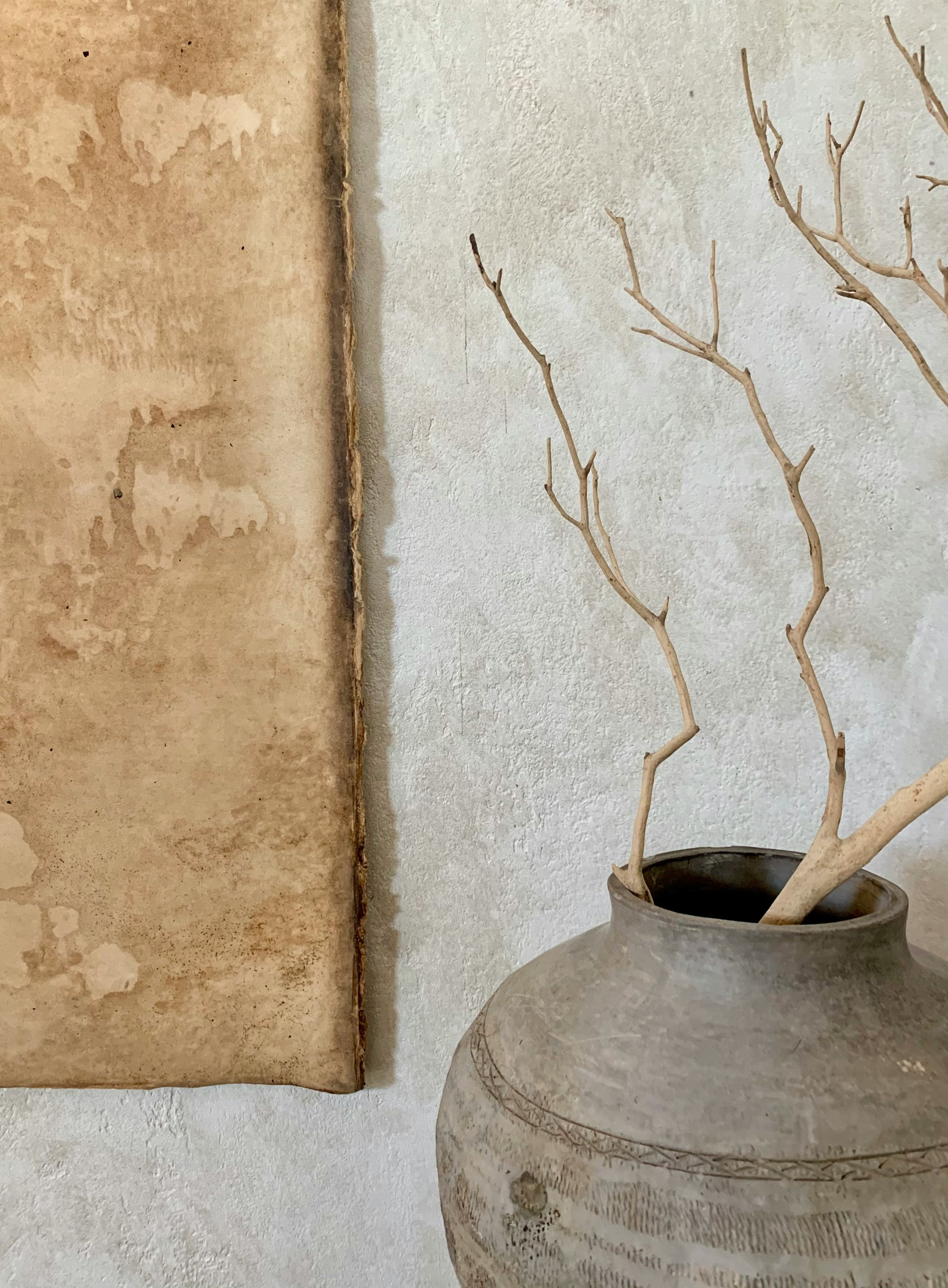 Dried tree branches in a rustic vase