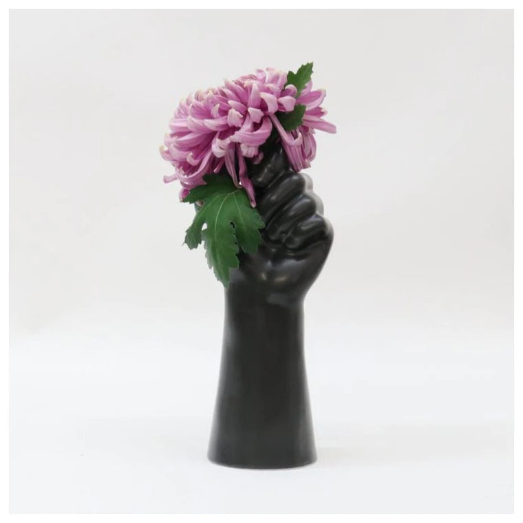 Black ceramic hand vase with beautiful pink fresh flower