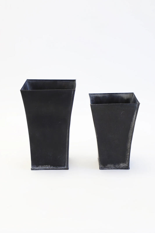 Two rustic black tin vases