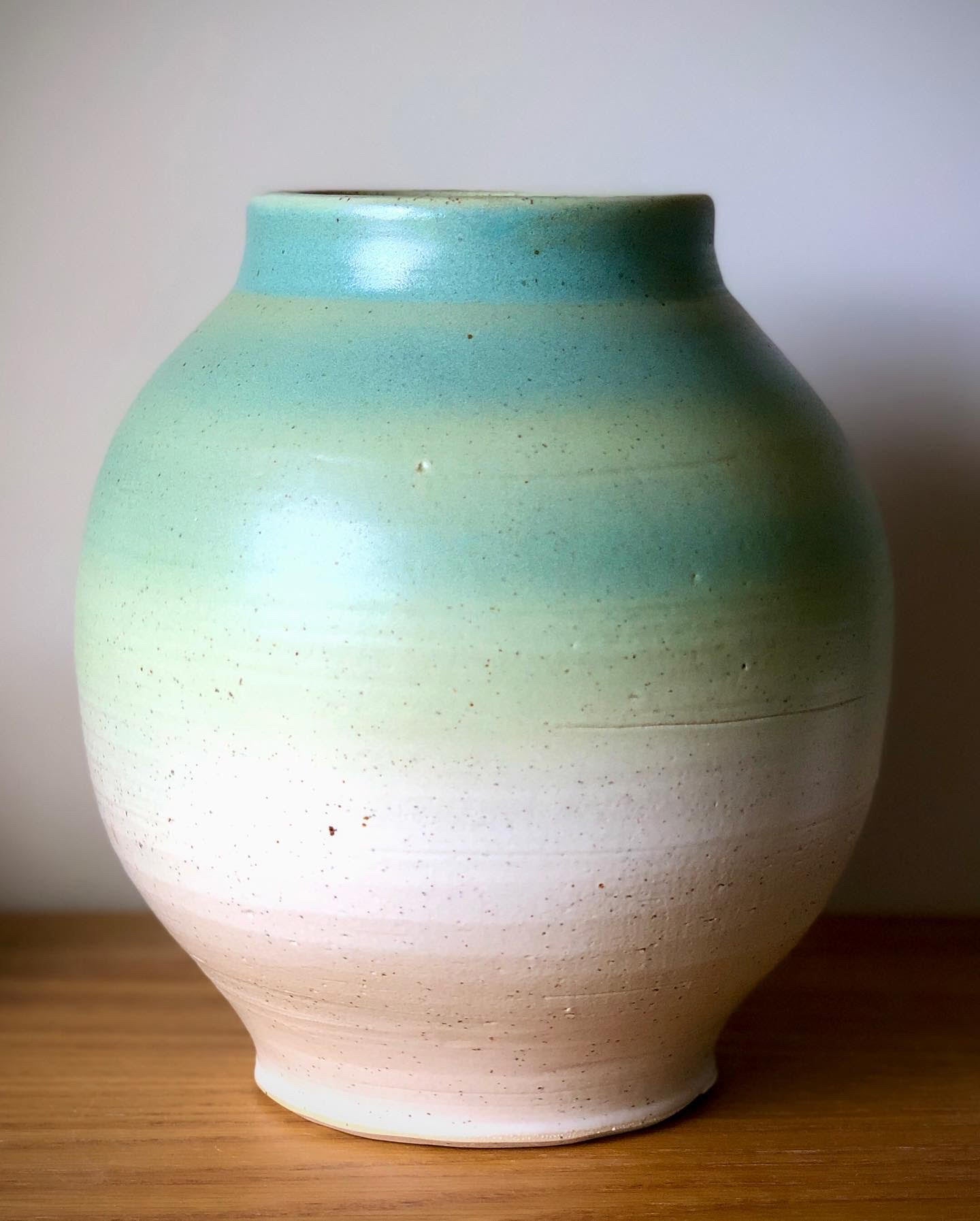 Large hand made pottery vase with a blue to white glaze